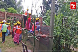 A group of women busy building houses under PMAY scheme in Dhemaji