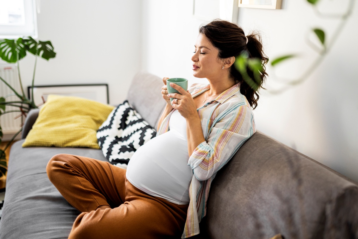 Pregnant woman drinking from a cup