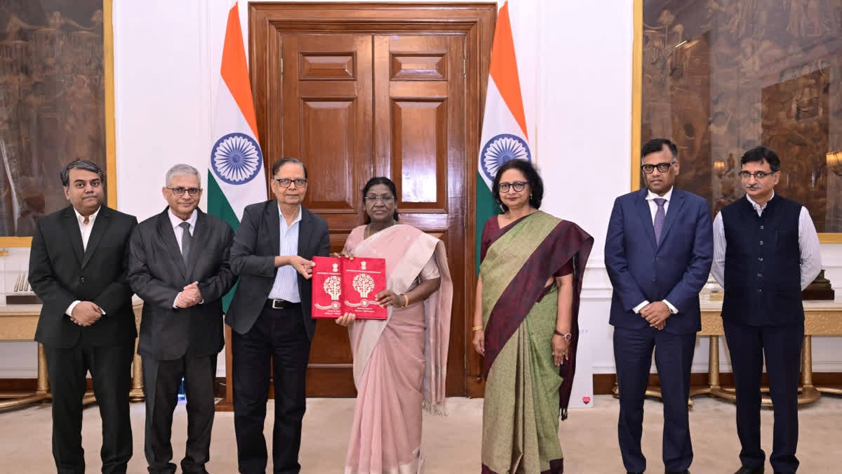 In this image posted on Nov. 17, 2025, President Droupadi Murmu receives the 16th Finance Commission's report for 2026-31 from Commission's Chairperson Arvind Panagariya, in New Delhi.