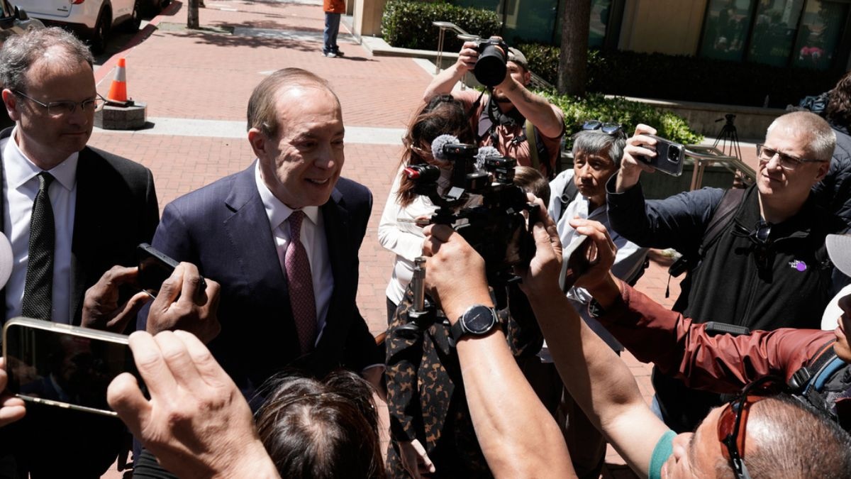 Steven F. Molo, attorney for Elon Musk, second from left, speaks to reporters outside the U.S. District Court, Monday, May 18, 2026, in Oakland, Calif.