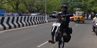 Keralam cyclist Saneed cycling on a one-wheeled bicycle