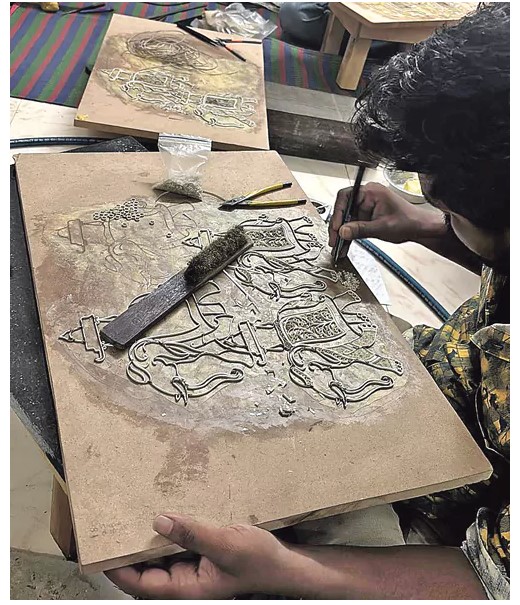 An artist making a filgree art