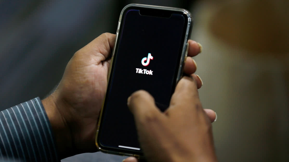 FILE - In this July 21, 2020 file photo, a man opens social media app 'TikTok' on his cell phone, in Islamabad, Pakistan.