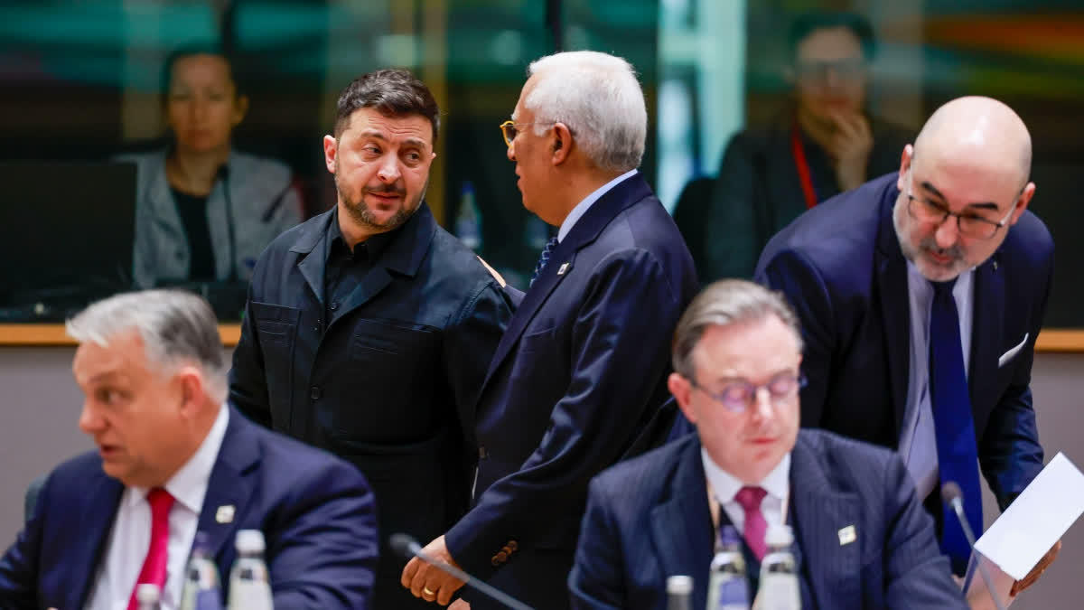 Ukraine's President Volodymyr Zelenskyy, second left, speaks with European Council President Antonio Costa, center rear, during a round table meeting at the EU Summit in Brussels, Thursday, Dec. 18, 2025.