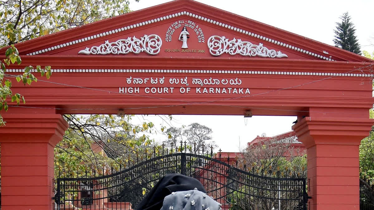 Women walk past the Karnataka High Court following the verdict of the Hijab issue, in Bengaluru.