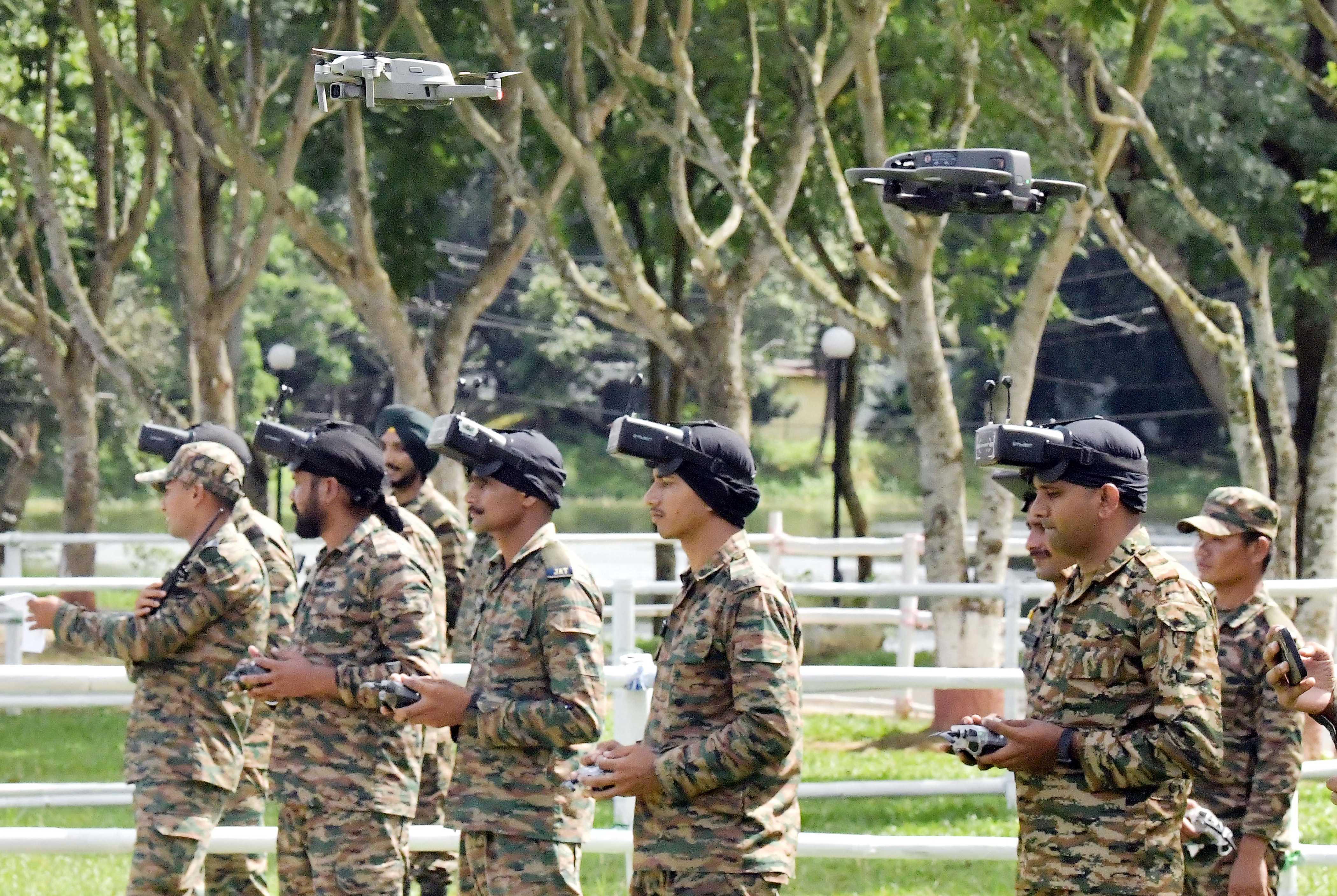 Army soldiers operate various drones used in warfare during a demonstration at the Assam Rifles ground in Agartala