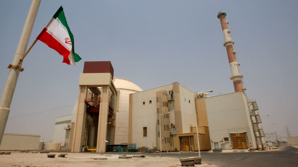 FILE - An Iranian flag flutters in front of the reactor building of the Bushehr nuclear power plant, just outside the southern city of Bushehr, Iran, Aug. 21, 2010.