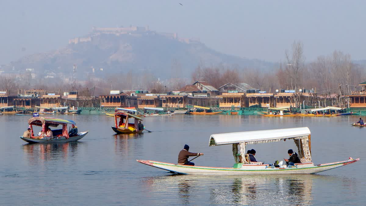Shikaras row in the iconic Dal Lake in the backdrop of Koh-e-Maraan hilltop in Srinagar, Jammu and Kashmir