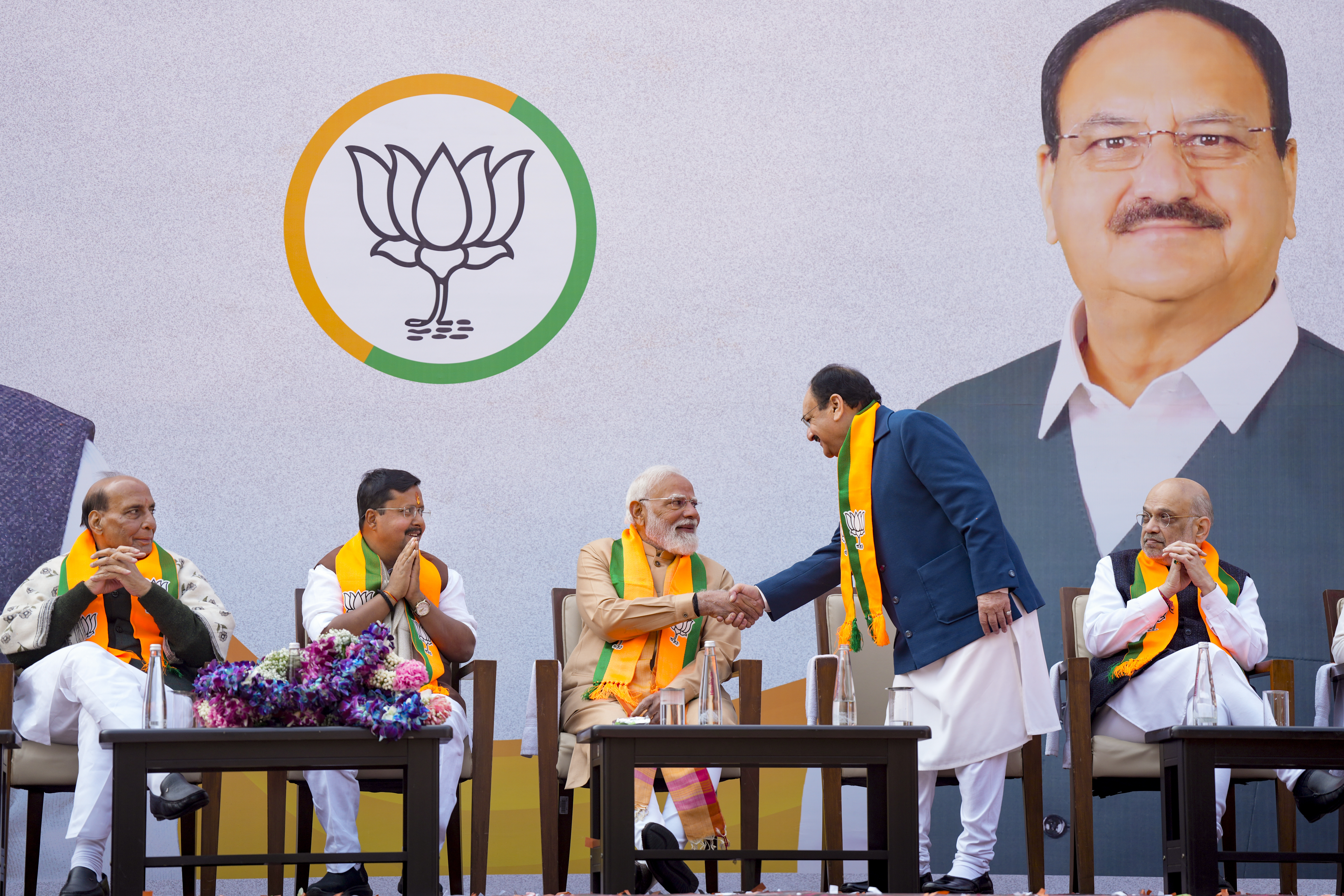Newly elected BJP National President Nitin Nabin looks on as Prime Minister Narendra Modi is greeted by Union Minister and outgoing party president JP Nadda during Nabin's charge-taking ceremony, at party headquarters, in New Delhi, Tuesday, Jan. 20, 2026.