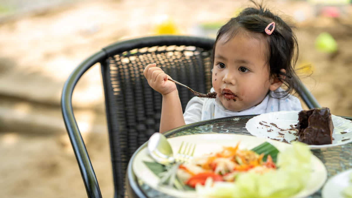 Little girl eating cake