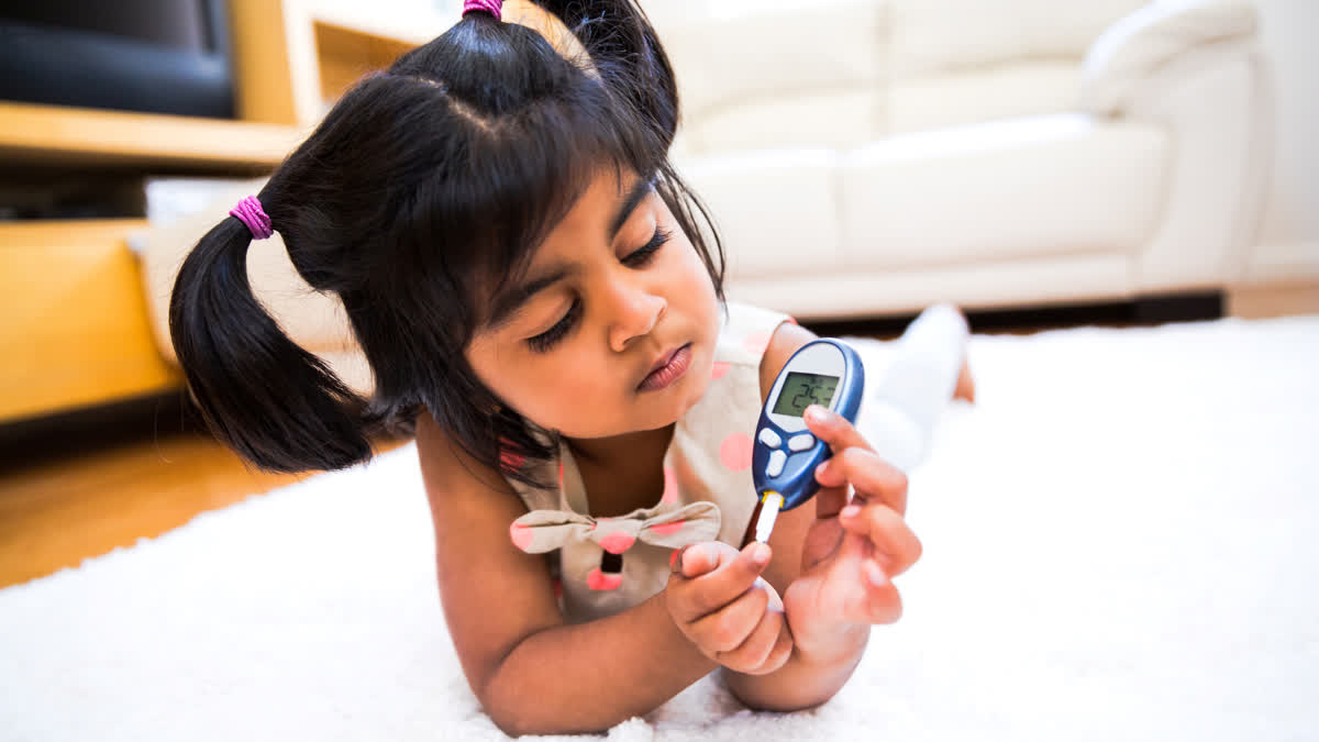 Girl with glucose monitor