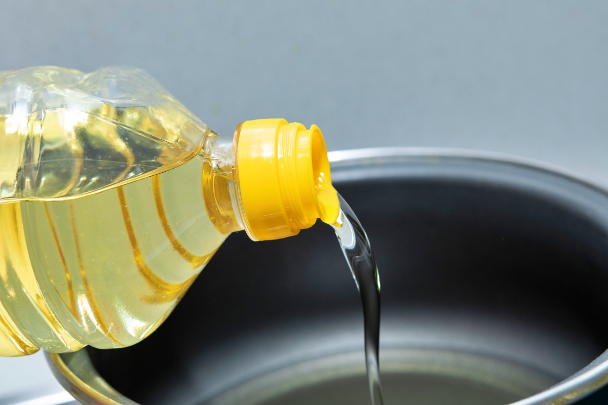 Pouring cooking oil into a pan