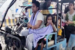 Rajini with her daughter on e-rickshaw