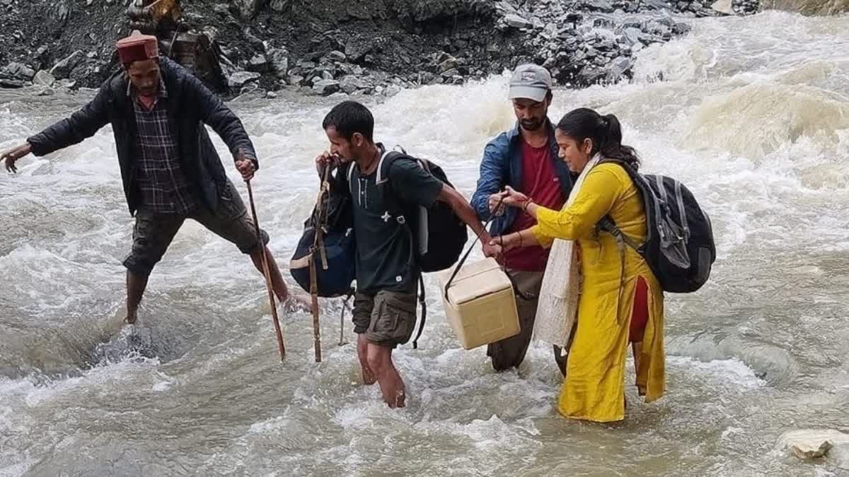 UTTARKASHI VILLAGERS CROSSING RIVER