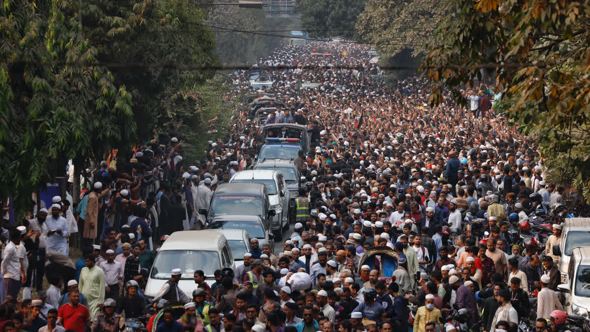 A convoy carrying the body of Sharif Osman Hadi, a student leader, who died after being shot in the head, moves along the crowd after the funeral prayer, in Dhaka on Saturday.