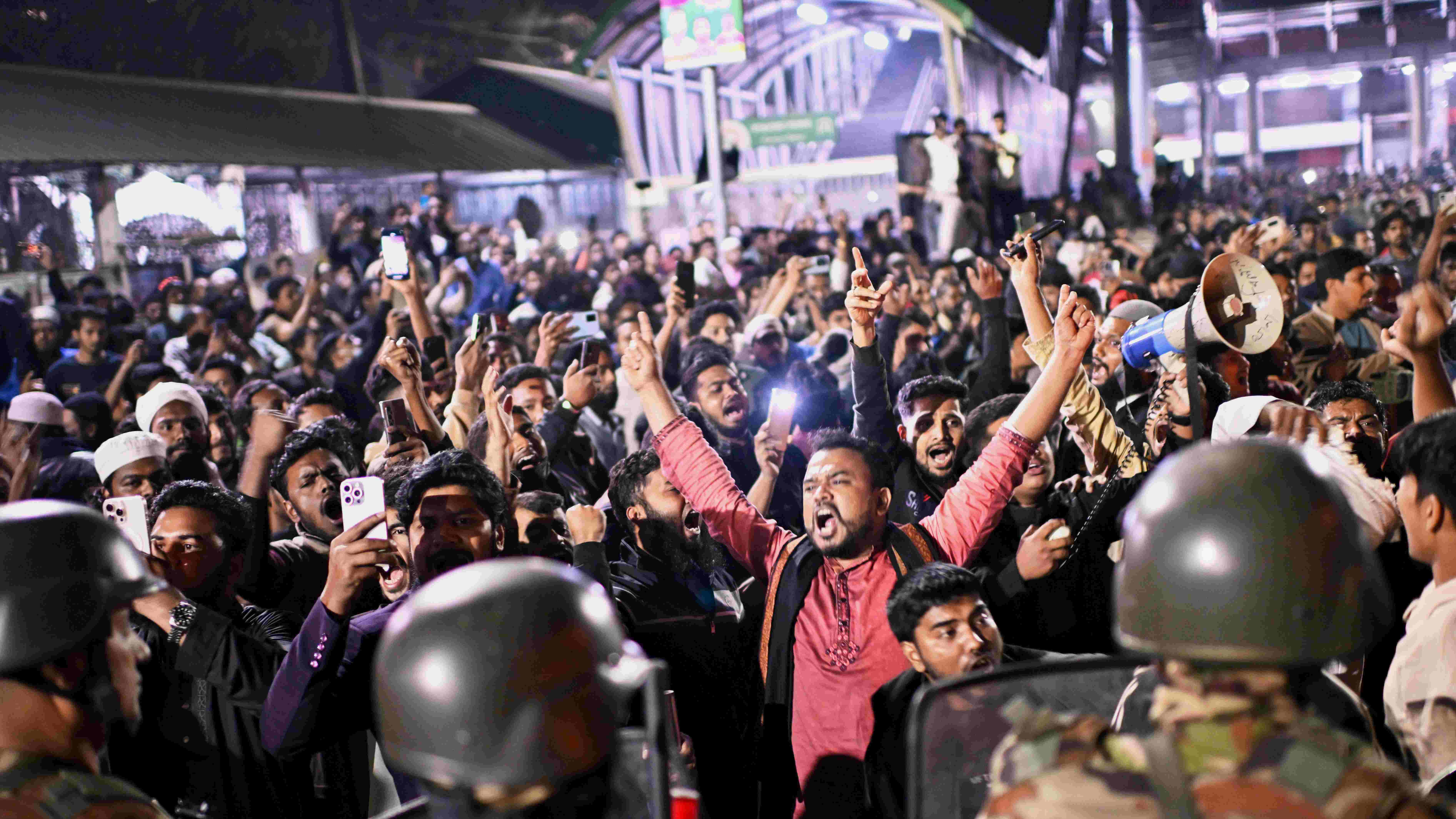 Protesters shout slogans in front of the premises of the Prothom Alo daily newspaper after news reached the country from Singapore of the death of a prominent activist Sharif Osman Hadi, in Dhaka, Bangladesh, Friday, Dec. 19, 2025.