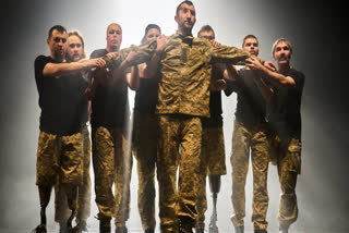 Ukrainian war veterans perform during a premiere in Kyiv, Ukraine.