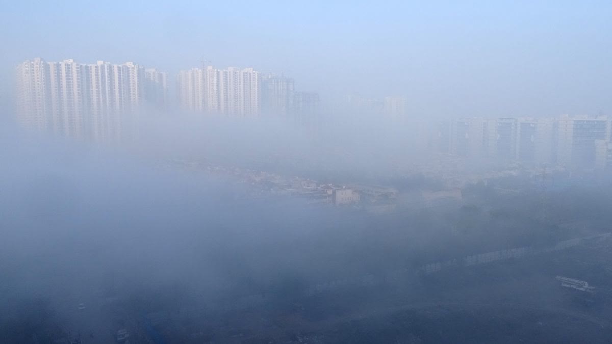 A layer of smoke engulfs parts of the city in Noida on Saturday, March 21