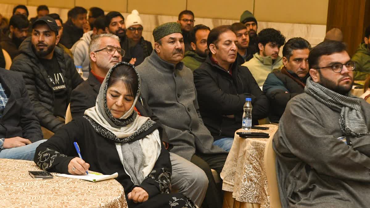 PDP President Mehbooba Mufti(writing) at a party event