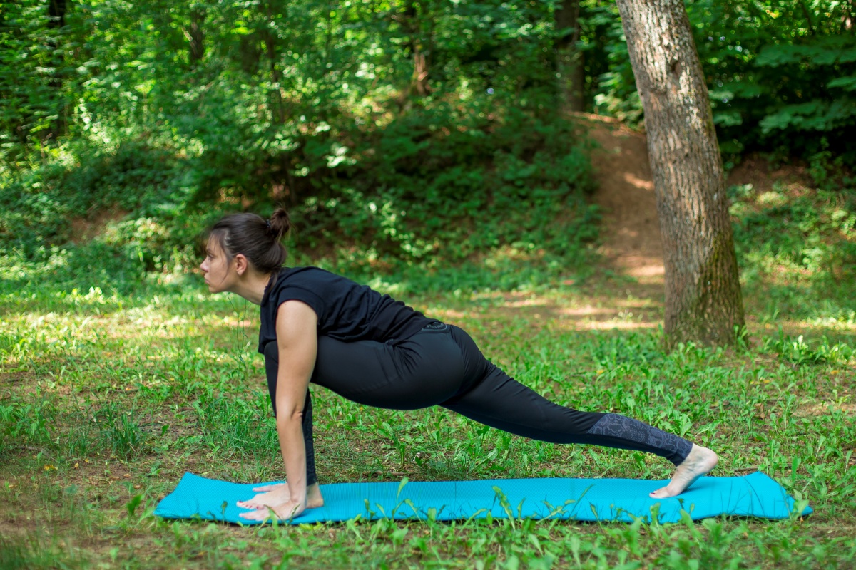 Woman doing surya namaskar in the park