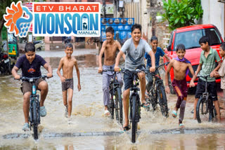 Children cycling in the rain