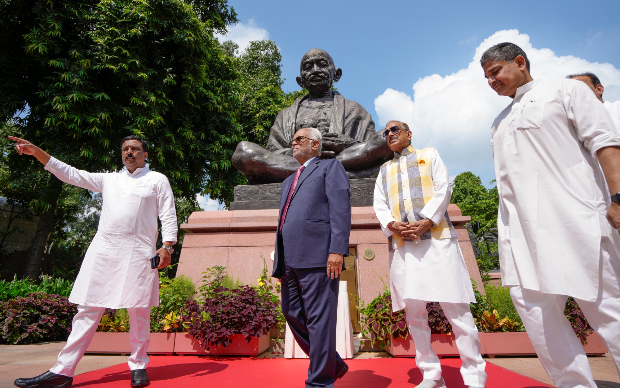 B Sudershan Reddy, center, with Congress leader Pramod Tiwari and others visits the Gandhi Statue, before filing his nomination, at the Parliament House complex, in New Delhi, Thursday, Aug. 21, 2025.