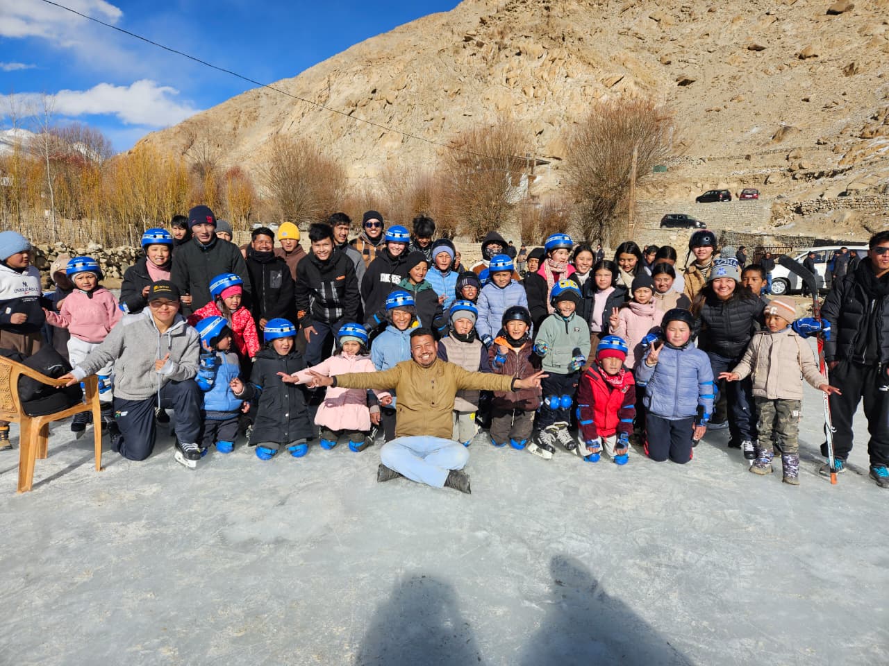 Rigzin Yangdol with the ice hockey players in Sakti village.