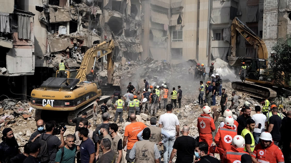 Death Toll In Israeli Airstrike On Beirut Reaches 31; 7 Women, 3 Children Among Killed Emergency workers use excavators to clear the rubble at the site of Friday's Israeli strike in Beirut's southern suburbs, Saturday, Sept. 21, 2024.