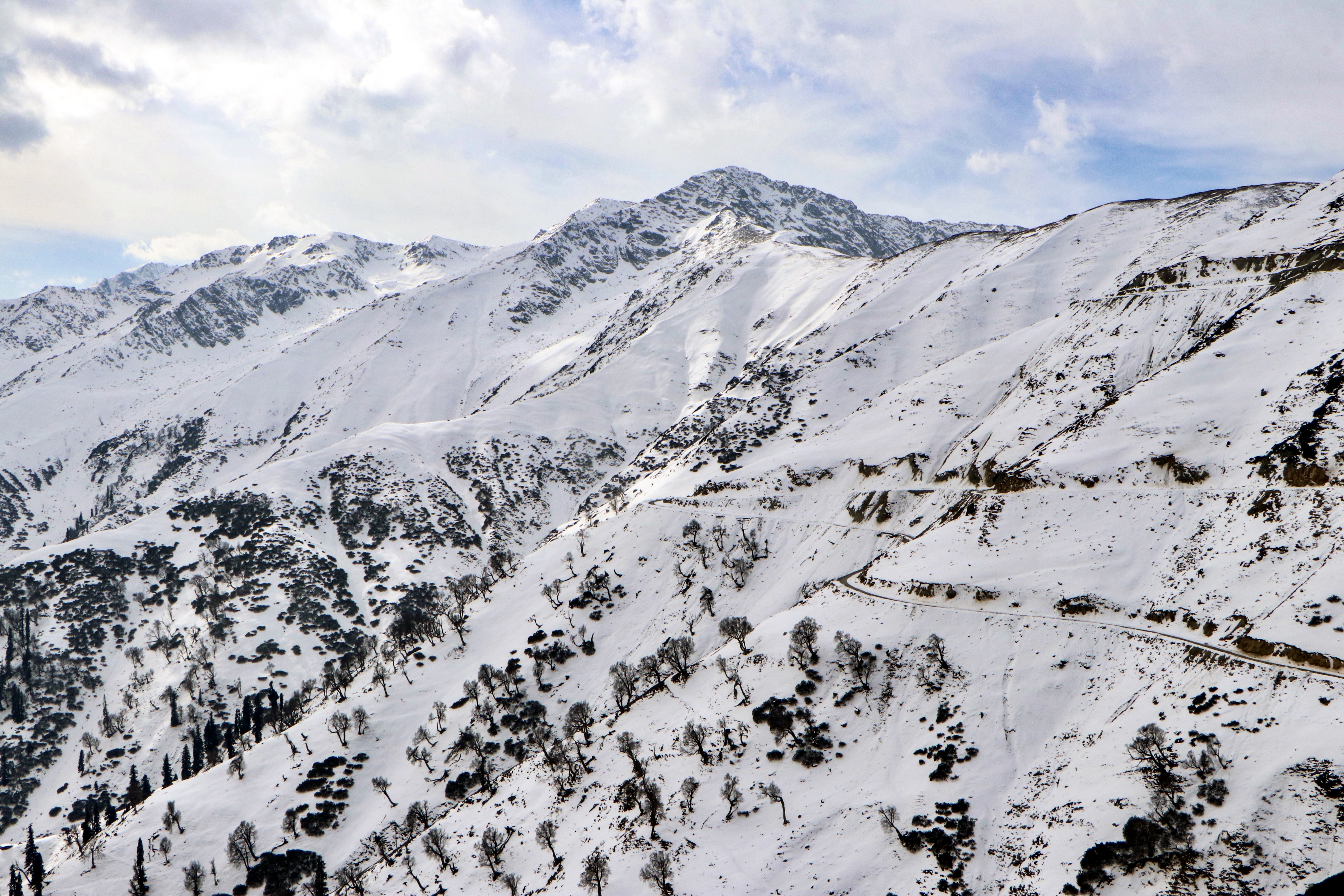 A breathtaking view of snow-laden mountain peaks at Sinthan Top, Jammu and Kashmir
