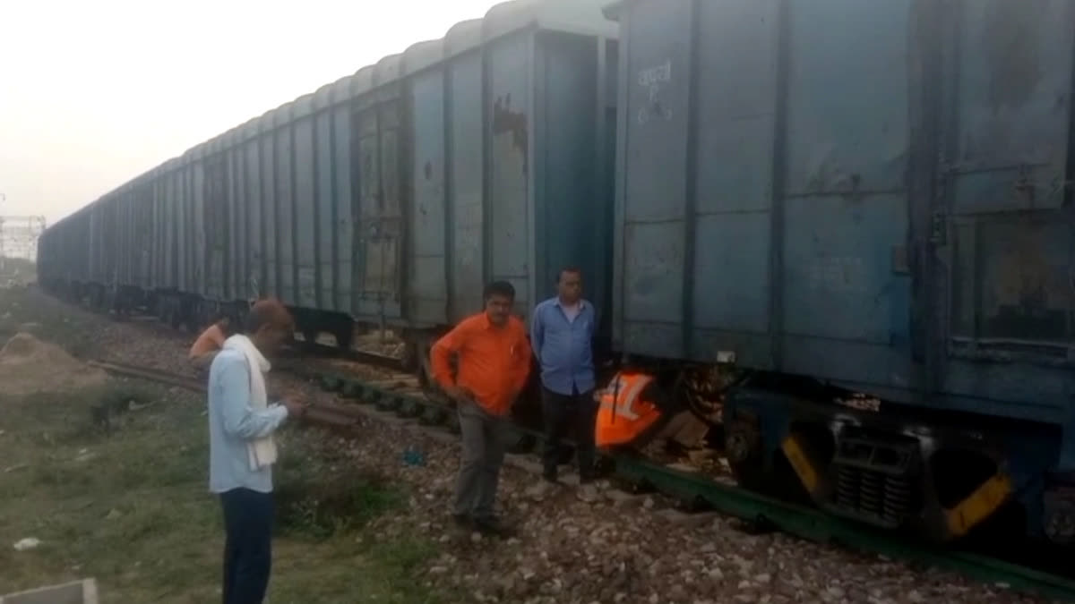 Workers inspecting a freight train