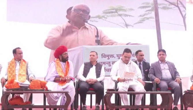 CM and others seated on the stage