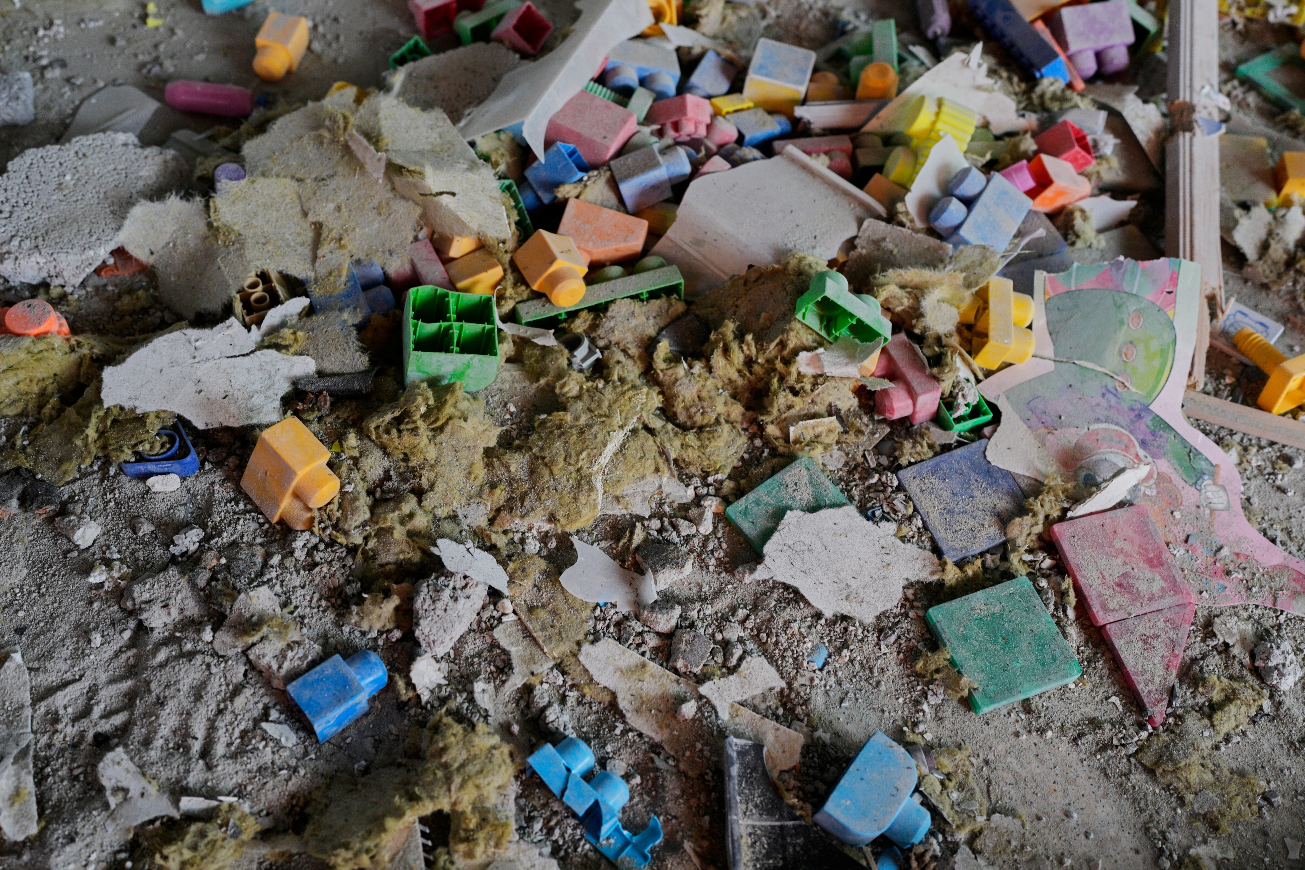 Toys and rubble at a kindergarten hit by fragments of an Iranian missile in Rishon LeZion, Israel, Saturday, March 21, 2026