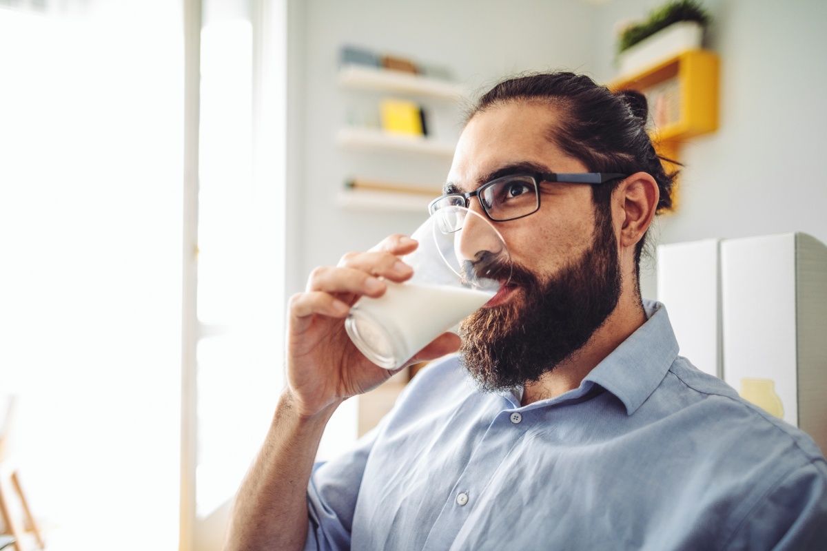 Bearded man drinking milk