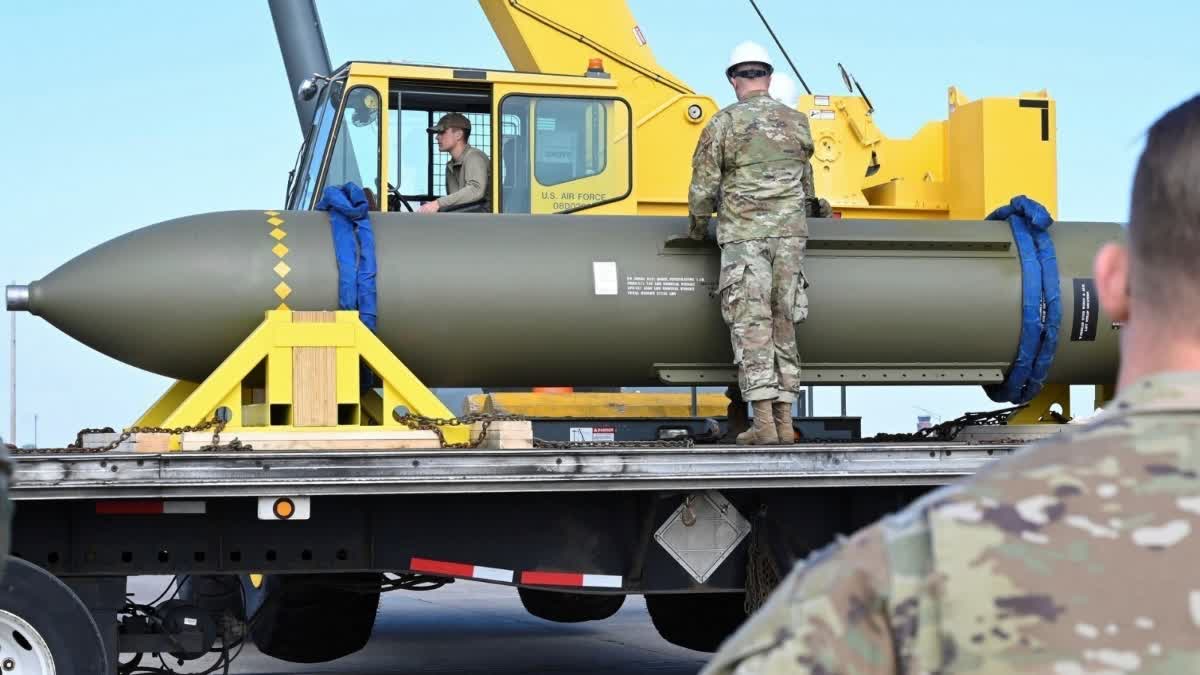 In this photo released by the U.S. Air Force on May 2, 2023, airmen look at a GBU-57, or the Massive Ordnance Penetrator bomb, at Whiteman Air Base in Missouri