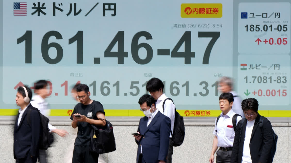 Crude Prices Drop, Most Stocks Rise On 'Positive' US-Iran Talks Pedestrians stand in front of electronic boards displaying the foreign exchange rate of the Japanese yen against the US dollar (L) and other currencies (R), along a street in Tokyo on June 22, 2026.