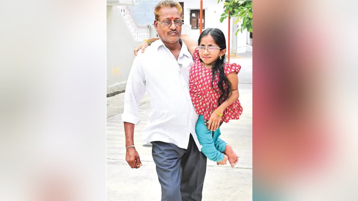 Father Sunkoju Venkatachari holding his daughter Shivani