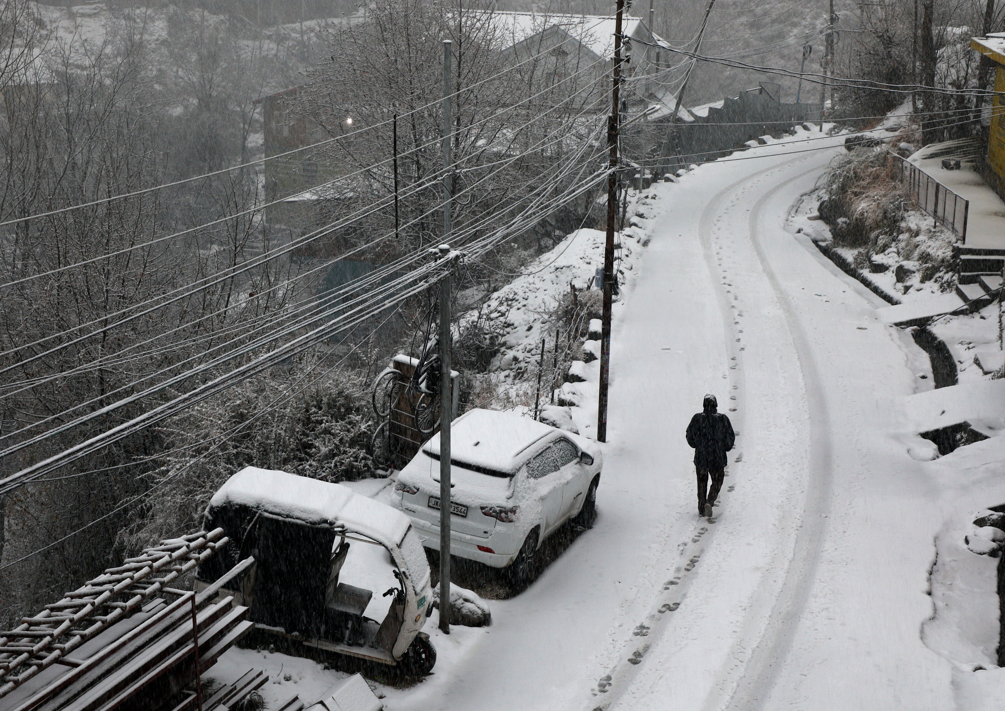 Doda: A man walks through snow amid fresh snowfall at Bhaderwah, in Doda district, Jammu and Kashmir, Friday, Jan. 23, 2026.