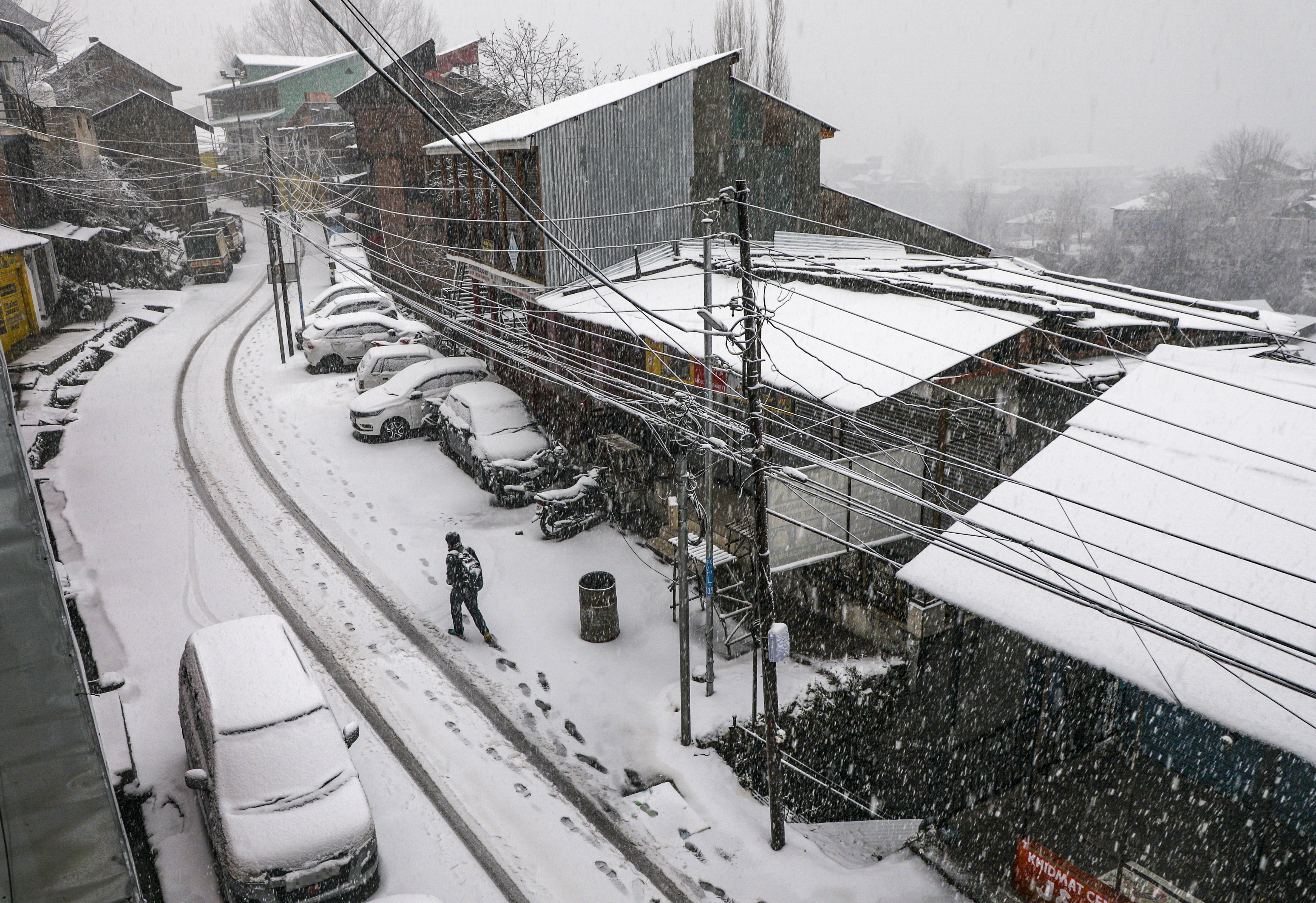 Doda: A local walks amid heavy snowfall at Bhaderwah, in Doda district, Jammu and Kashmir, Friday, Jan. 23, 2026.