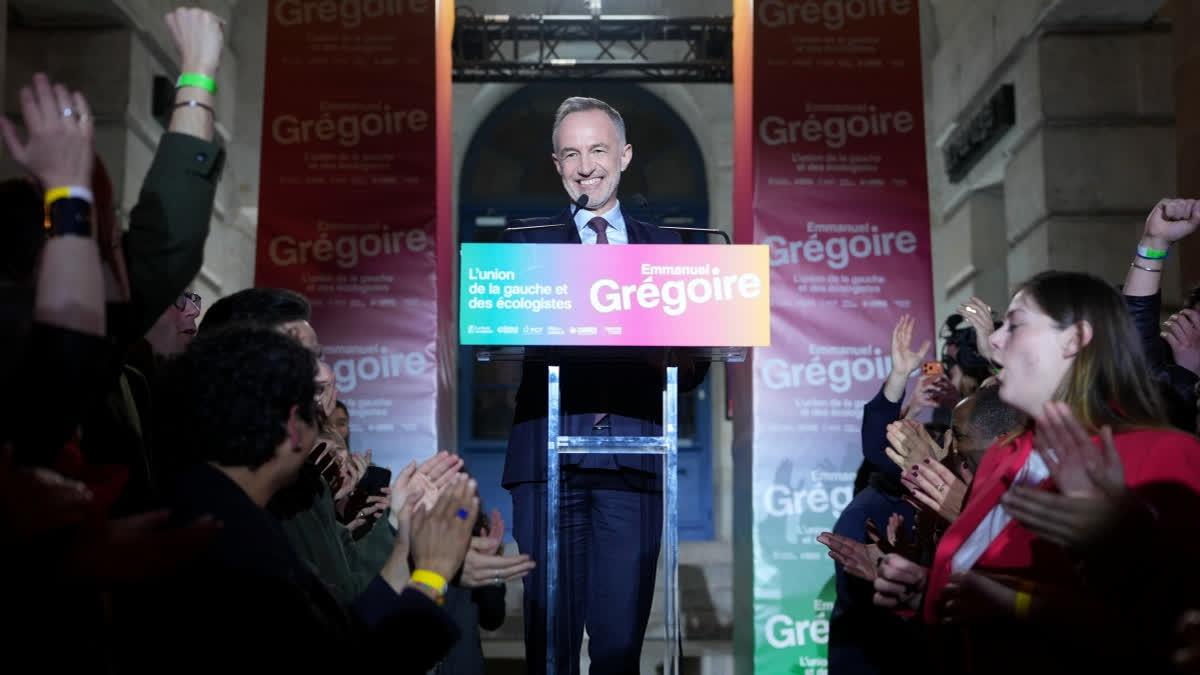 French socialist candidate for Paris mayoral election, Emmanuel Gregoire, center, celebrates after he won the second round of France's municipal elections in Paris, France, Sunday, March 22, 2026.