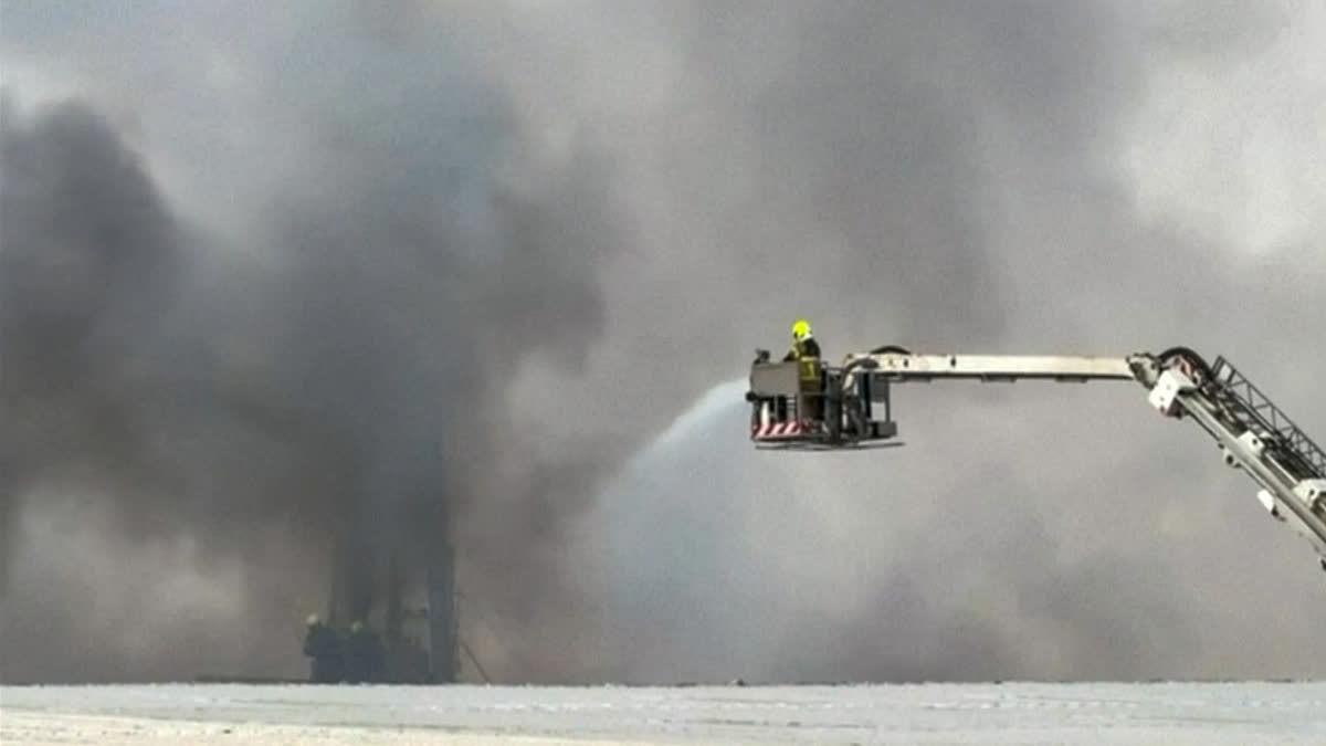 Indian National Injured By Falling Debris After Missile Incident In Abu Dhabi This image taken from a video shows firefighters trying to extinguish a fire which, according to the authorities was caused by a successful interception, at Dubai's Al Quoz Industrial area, United Arab Emirates, Friday, March 13, 2026.
