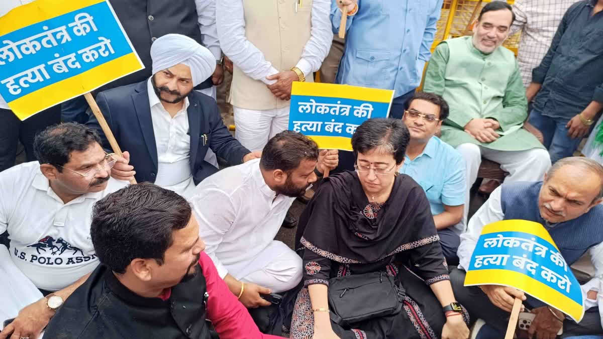 AAP MLAs protest outside the Delhi Assembly with posters during the Budget Session.