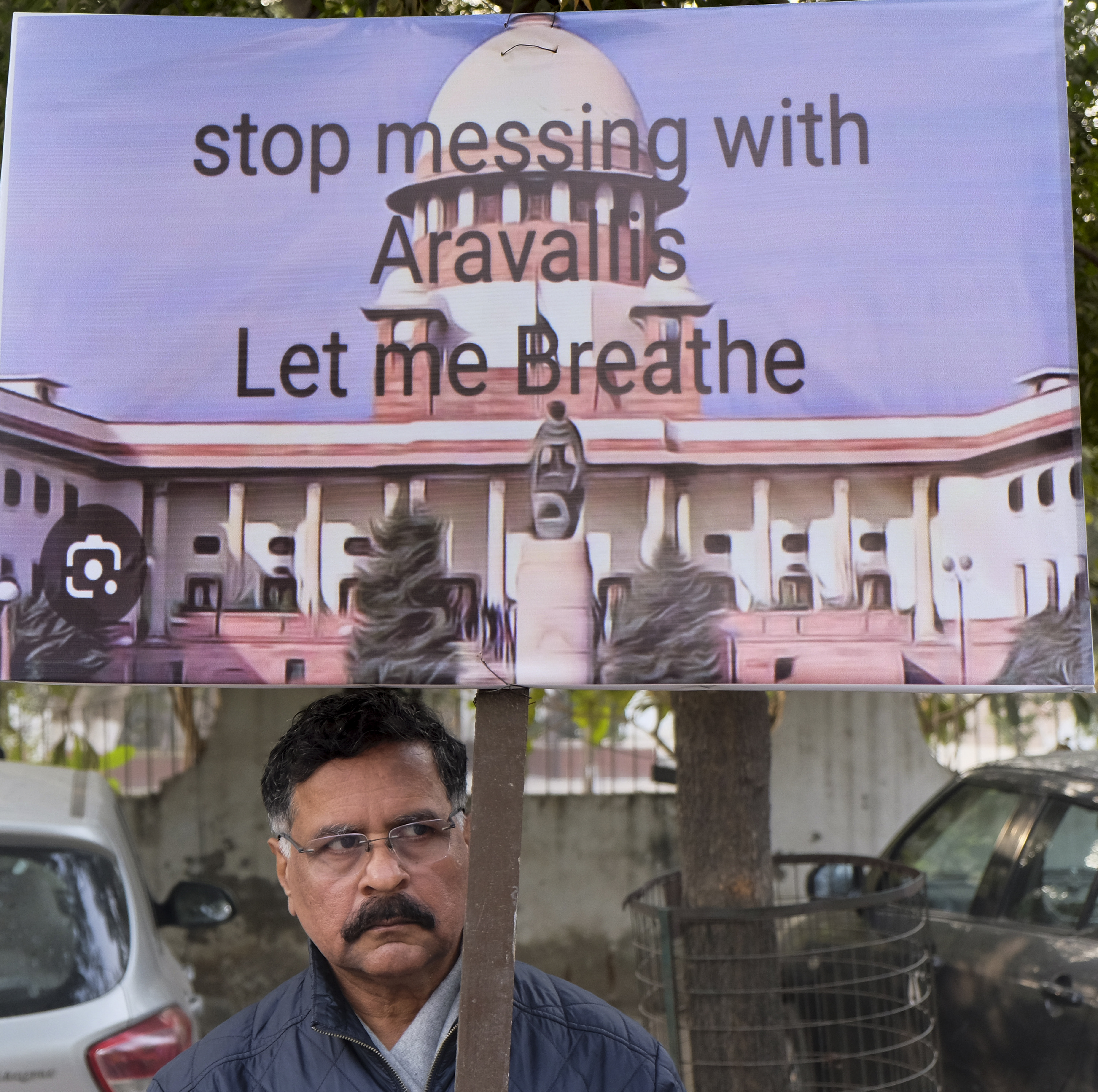A member of 'Aravalli Bachao Sanstha' during a demonstration as part of the Save Aravalli movement, near the residence of Haryana minister Rao Narbir Singh, in Gurugram