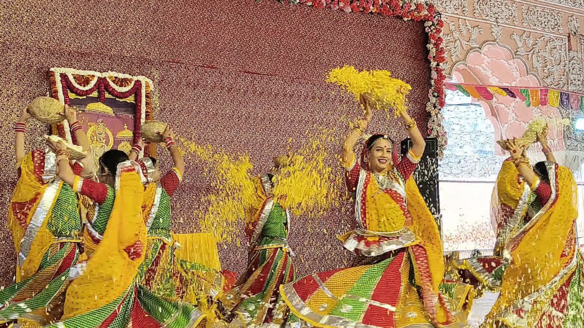 Artists playing Holi with flowers