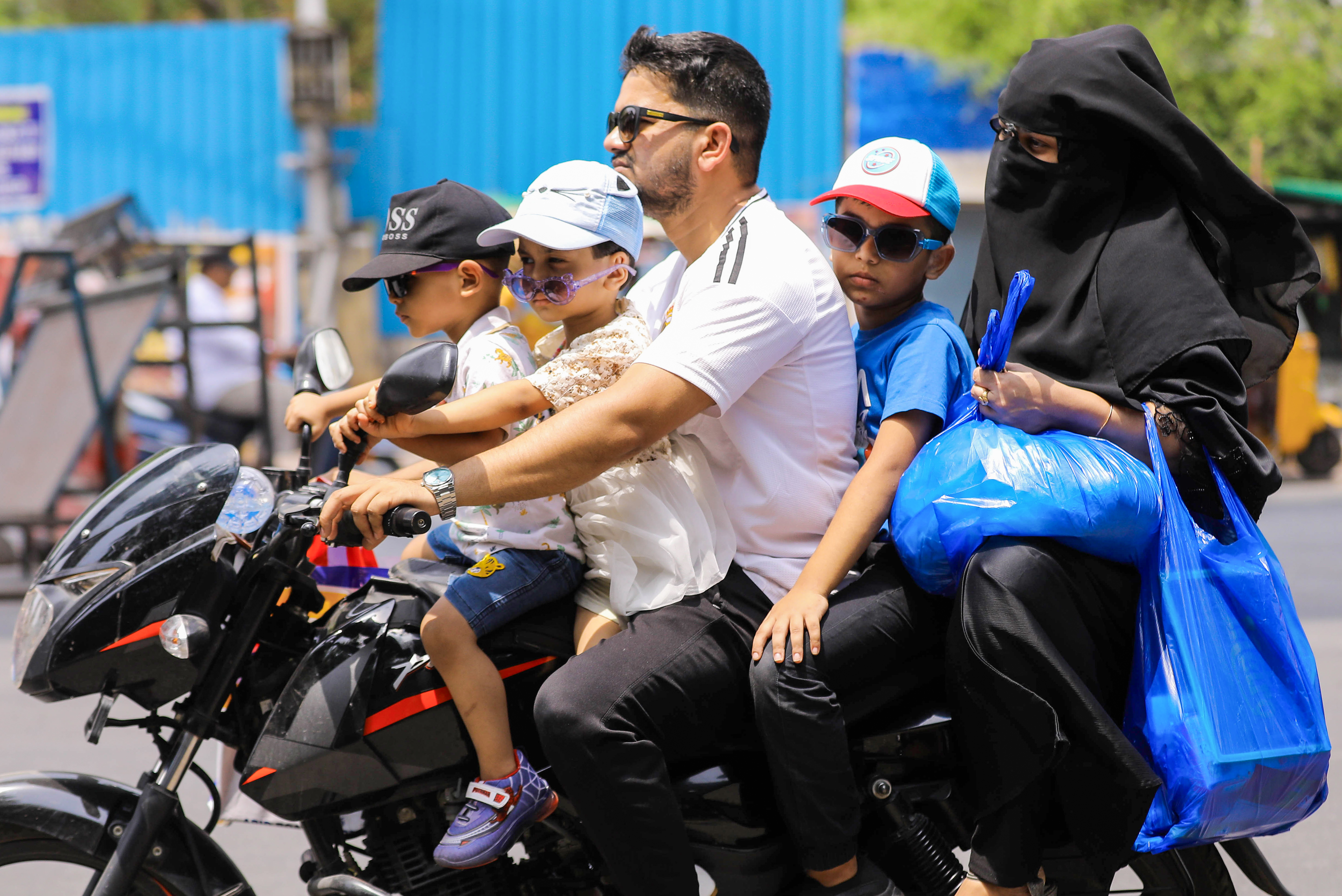 A family travels on a two-wheeler amid intense heatwave conditions and rising temperatures in Hyderabad, Telangana on Saturday, May 23, 2026.