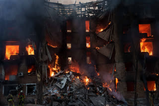 Rescue workers put out a fire of residential building destroyed after a Russian strike in Kyiv, Ukraine, on Sunday, May 24, 2026.