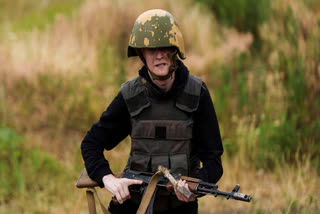 A Ukrainian 3rd Assault Brigade recruit runs to take a position during a training at the polygon in Kyiv region, Ukraine, on Wednesday, July 16, 2025.