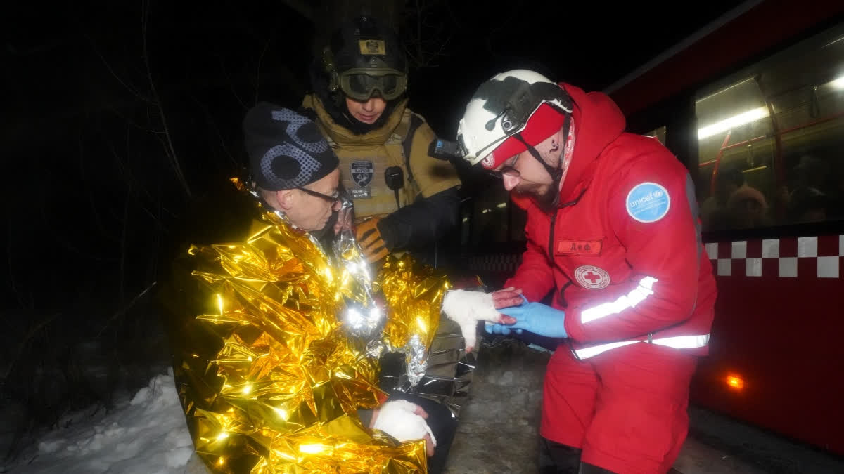 A paramedic gives first aid to a resident who was injured in a Russian airstrike in Kharkiv, Ukraine, Saturday, Jan. 24, 2026.