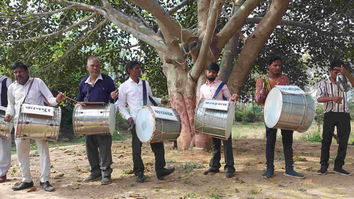 Villagers playing drums during the protest