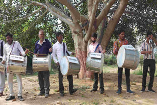 Villagers playing drums during the protest