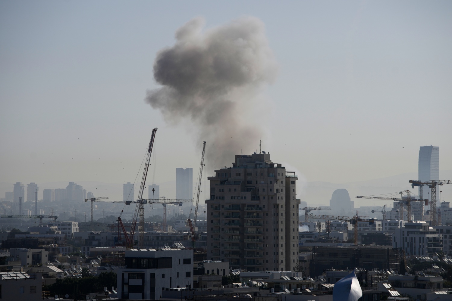 Smoke billows following an Iranian missile strike in Tel Aviv, Tuesday, March 24, 2026.